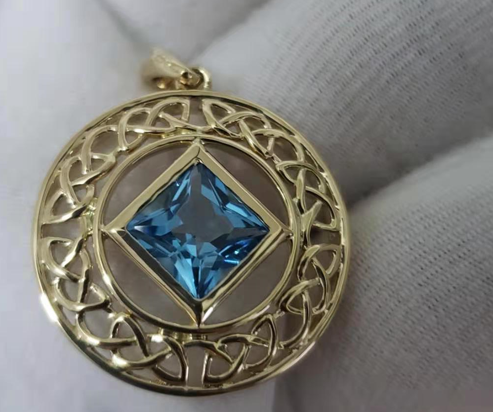 14 K Gold Blue Topaz NA Service Symbol Pendant image 0