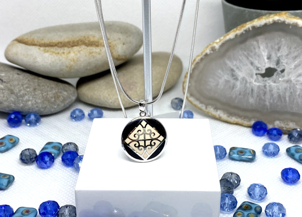 Small NA Pendant with black and white enamel image 0