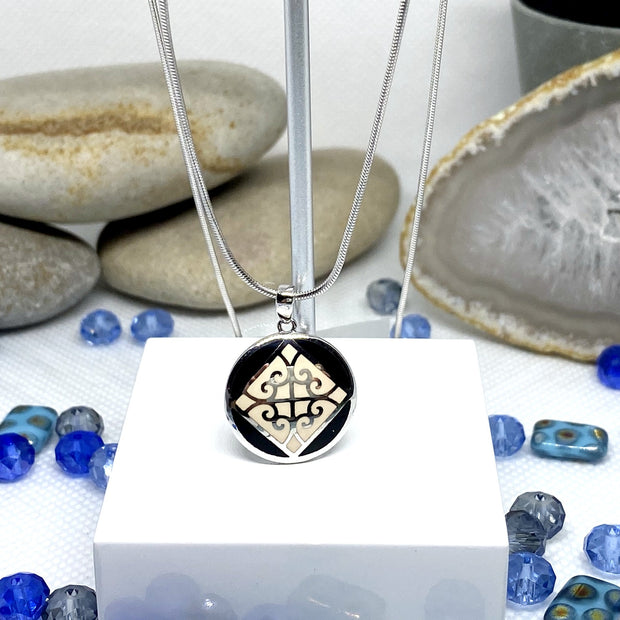 Small NA Pendant with black and white enamel image 0